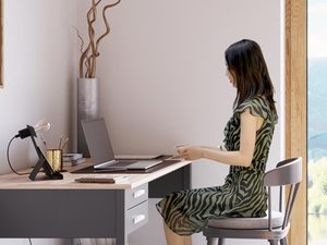 Miniaturka 3 - Kobieta pracująca przy białym biurku z designerską lampką LED