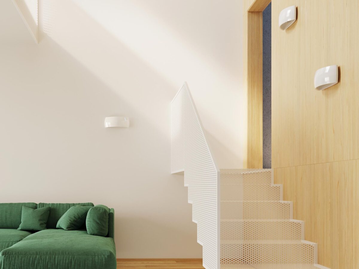 Minimalistyczny salon z zielonym narożnikiem