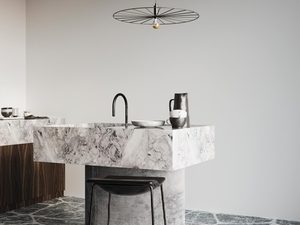 Miniaturka 2 - Kuchnia z betonową wyspą i wiszącą czarną lampą o ażurowej konstrukcji