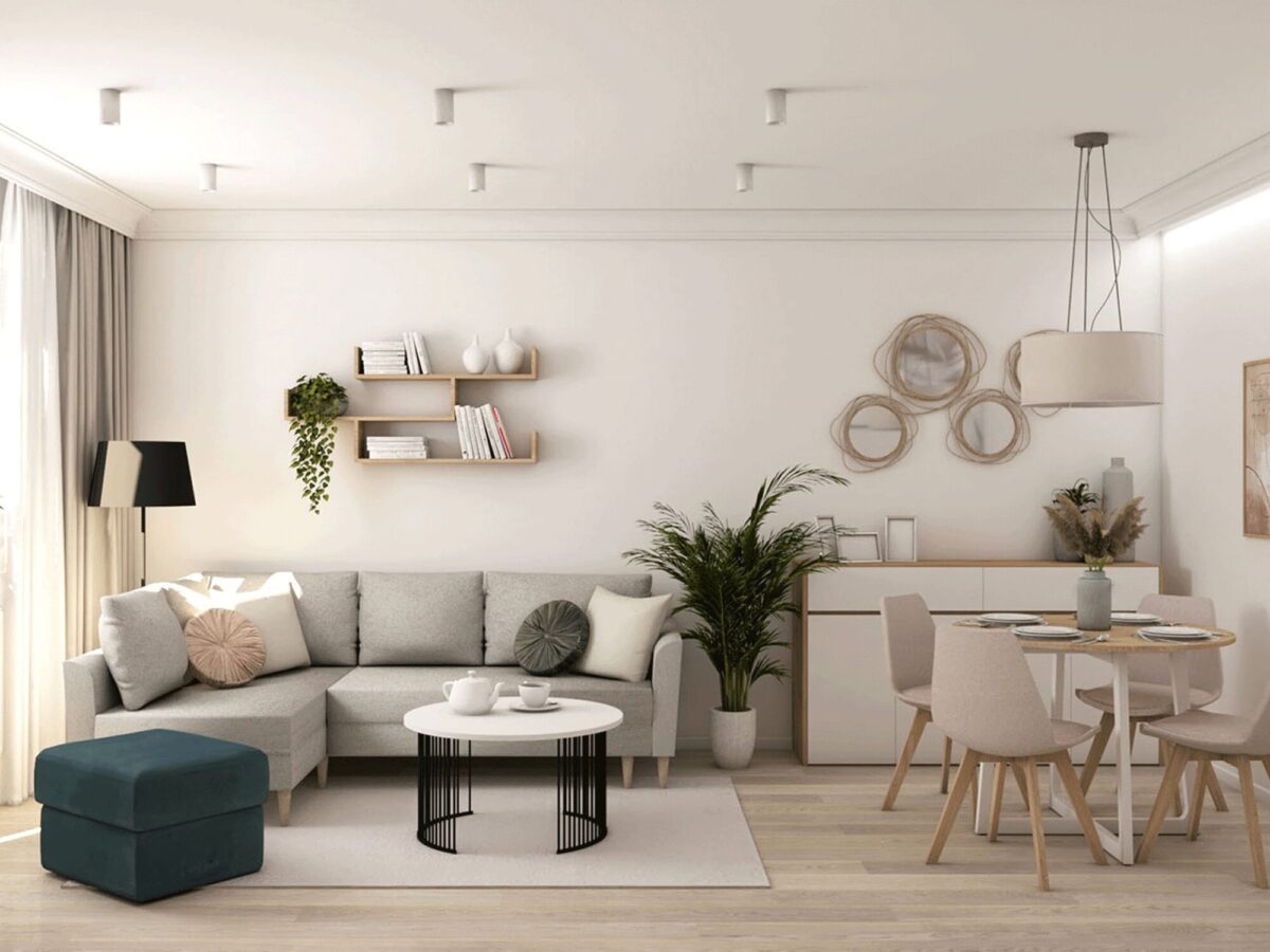 Białe meble i zielona sofa w jasnym salonie skandynawskim