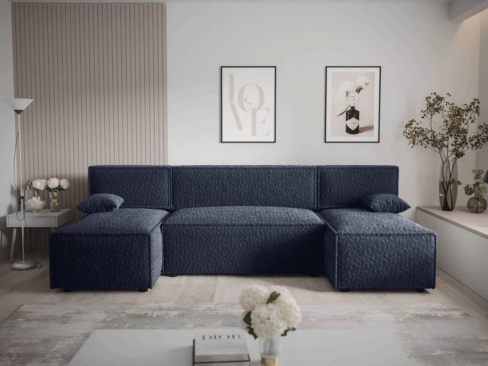 Granatowa sofa w stylu nowoczesnym z jasnymi dodatkami