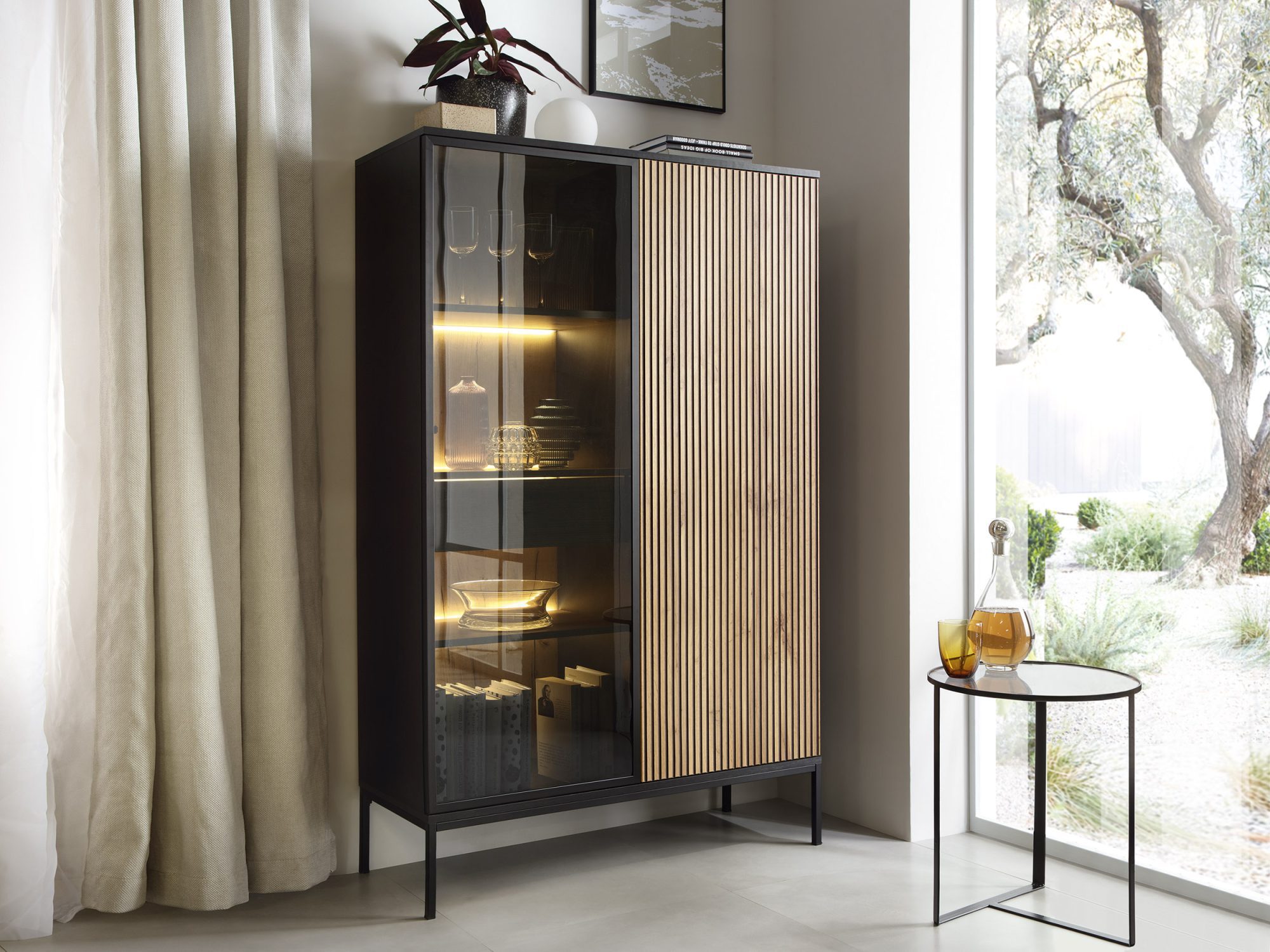 Przeszklona witryna z podświetleniem i drewnianymi półkami w salonie