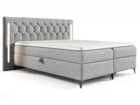 Łóżko tapicerowane w jasnoszarym kolorze z prostym, eleganckim wykończeniem