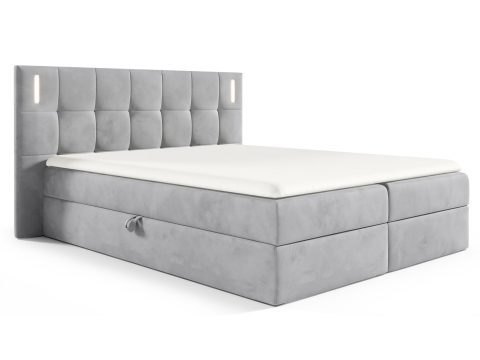 Łóżko tapicerowane w jasno szarym kolorze z pikowanym zagłówkiem
