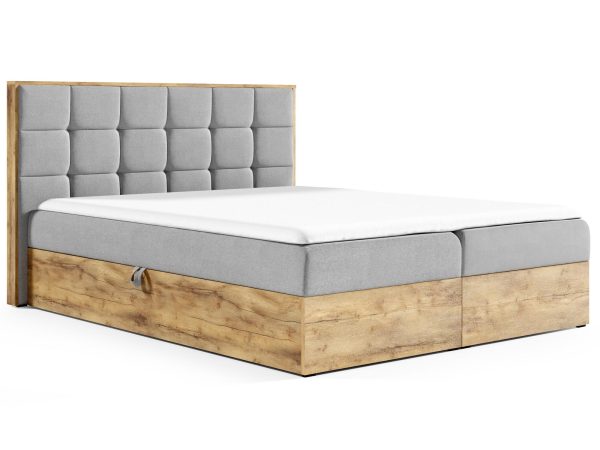 Drewniane łóżko z pikowanym zagłówkiem i miękką, jasną tapicerką