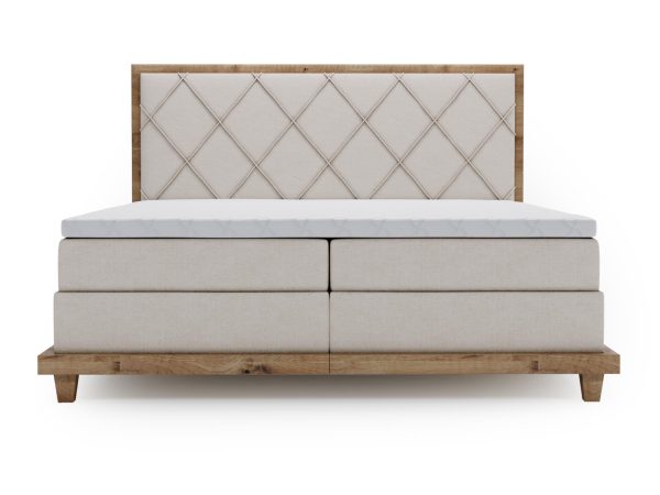 Beżowe łóżko tapicerowane z dużą powierzchnią spania