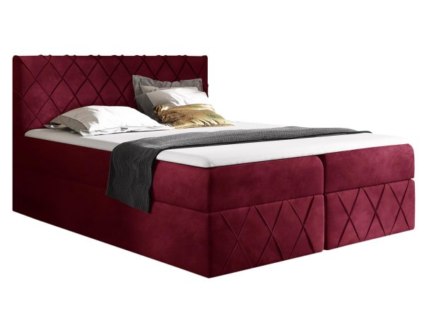 Łóżko tapicerowane w bordowym kolorze z pikowanym zagłówkiem