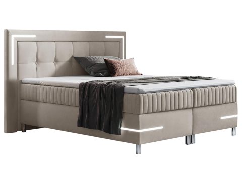 Nowoczesne łóżko tapicerowane w beżowym kolorze z metalowymi nóżkami