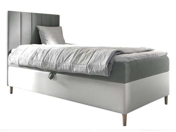 Szare łóżko z niskim zagłówkiem i grubym materacem.