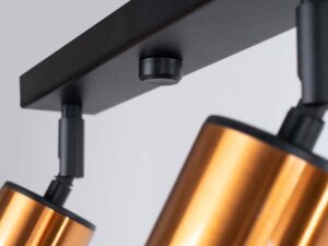 Miniaturka 6 - Detal mocowania złotego reflektora do czarnej listwy plafonu zbliżenie