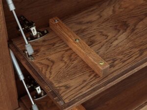 Miniaturka 13 - Detal klapy komody tabacco z siłownikami i drewnianym uchwytem