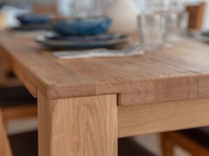 Miniaturka 2 - Detal narożnika blatu i nogi stołu dębowego z usłojeniem drewna
