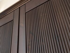 Miniaturka 4 - Detal gałki drzwi szafy trójdrzwiowej drewnianej ciemnobrązowej z ryflowanym panelem