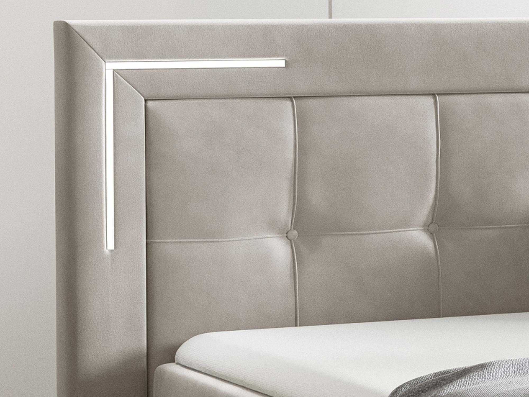 Detal pikowanego zagłówka kremowego łóżka elektrycznego