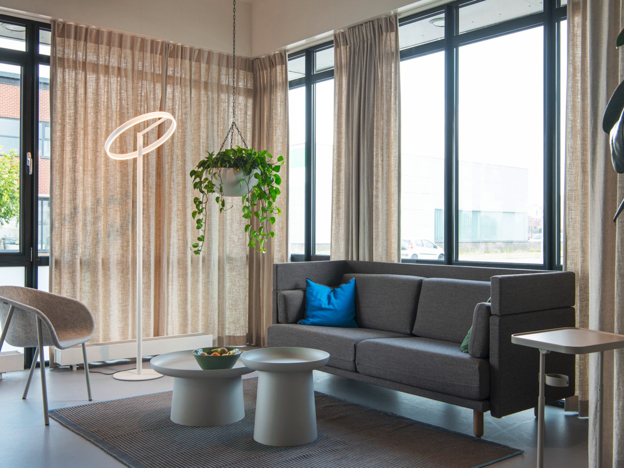 Lampa podłogowa One Straight FL biała przy szarej sofie