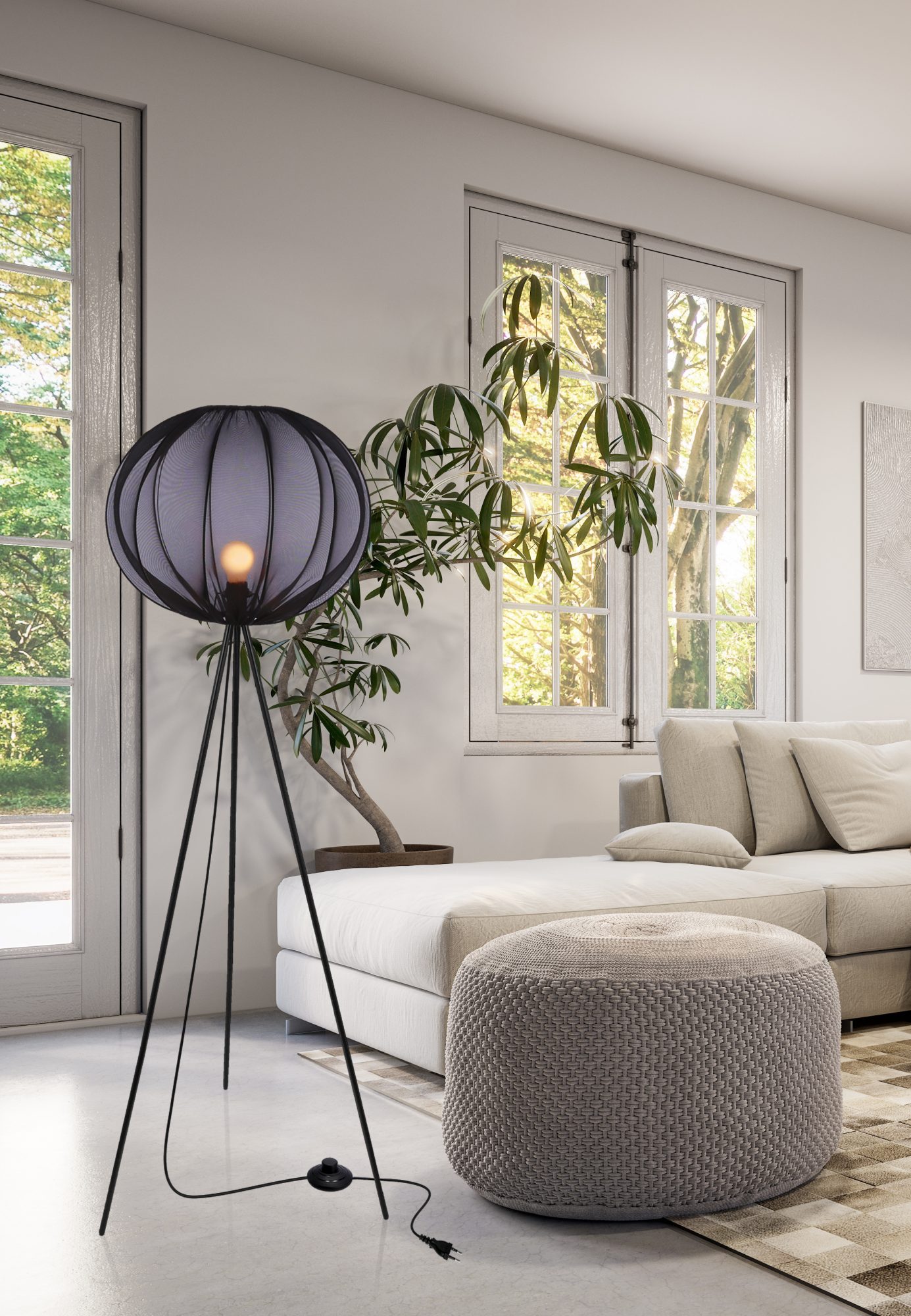 Lampa podłogowa Pelato czarna świeci obok jasnej sofy