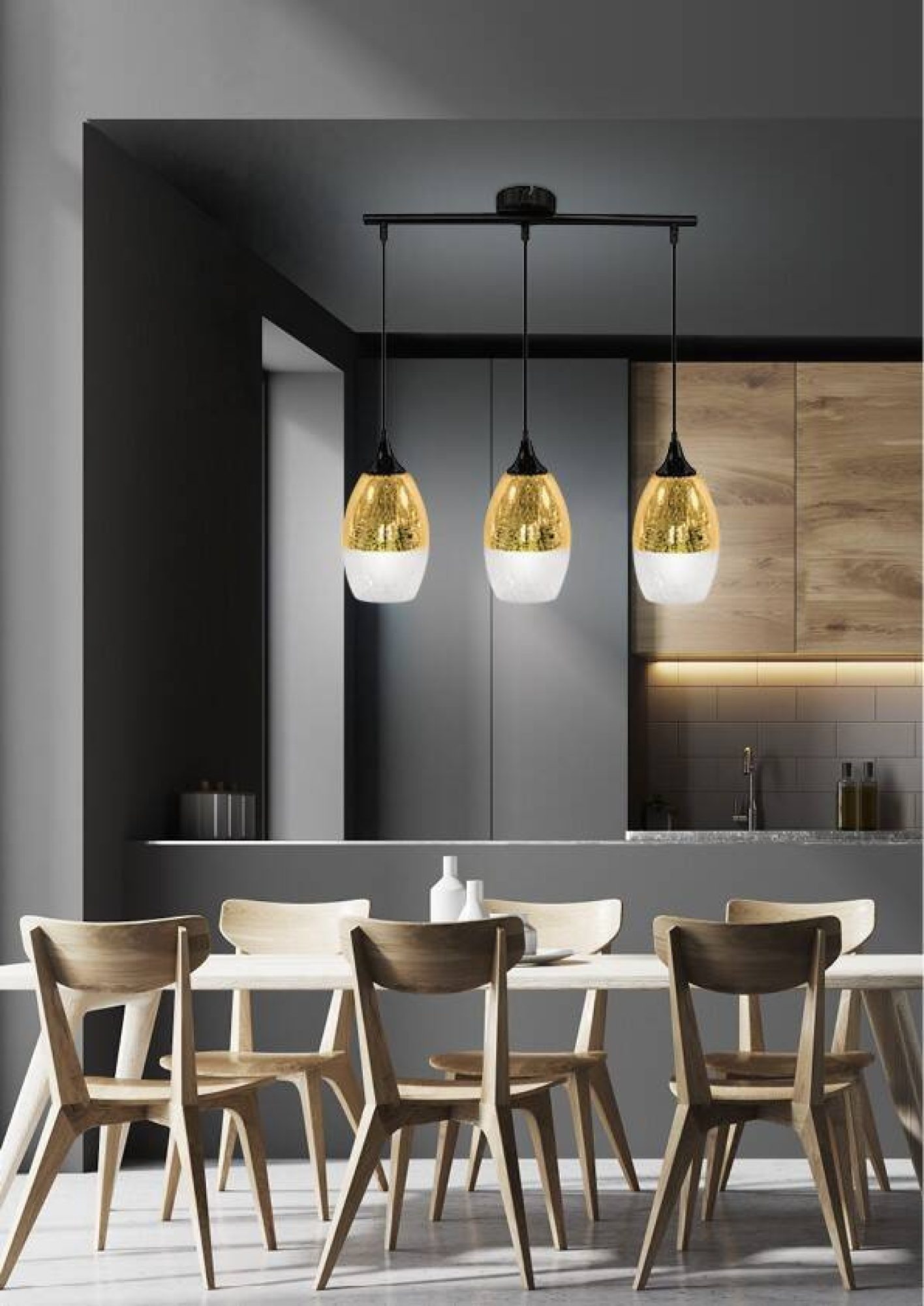 Lampa wisząca Ilvatio z trzema złotymi szklanymi kloszami nad stołem w jadalni