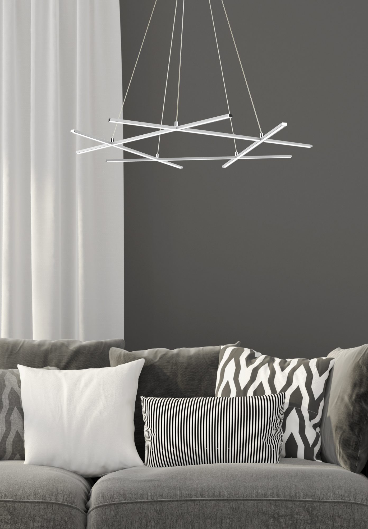 Srebrna lampa wisząca LED Valitano nad szarą sofą w salonie