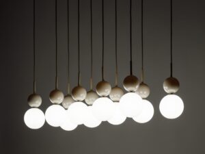 Miniaturka 1 - Lampa wisząca Riviera 10-punktowa z zapalonymi białymi kulami, detal beżowych mocowań